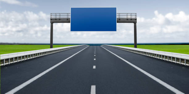 istock highway with blue sign above the roadway 2150160124