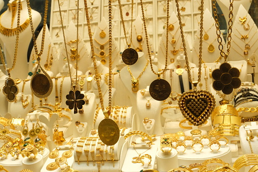 A rich collection of gold necklaces, bracelets, earrings and rings in the jewelry store window