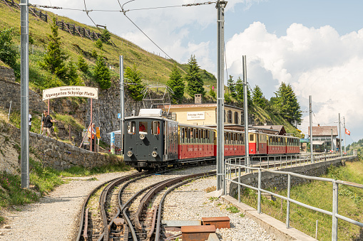 Old historical cogwheels in Schynige Platte railway station in the Swiss Alps. Vintage locomotive with old carriages in the mountain railway station. 10 july 2023, Schynige Platte, Switzerland