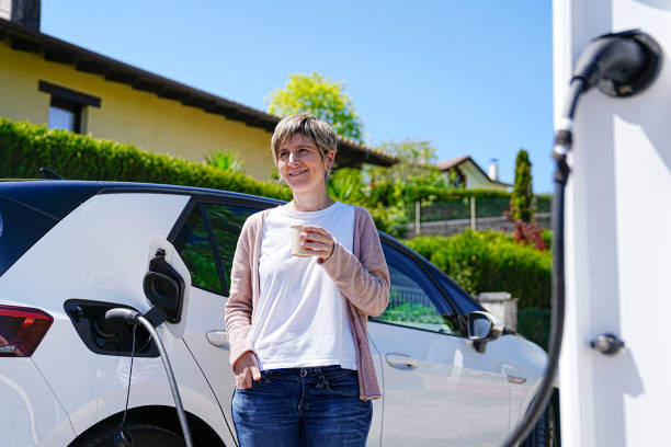 istock Happy Entrepreneur During Her Coffee Time by EV Charger 2150162376