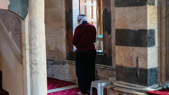 Gaziantep, Turkey - 14.04.2024: Religious Muslim man praying inside the Seyh Fethullah Mosque