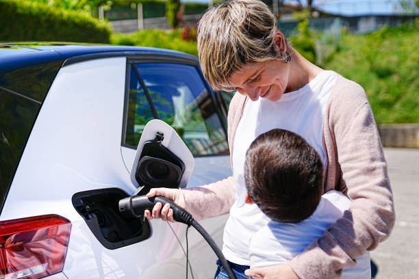 istock Happy Mother and Son at Electric Car Charging Session 2150162625