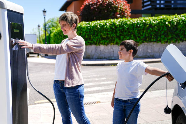 istock Enthusiastic Mother and Son Engage with Electric Car Charging 2150162941