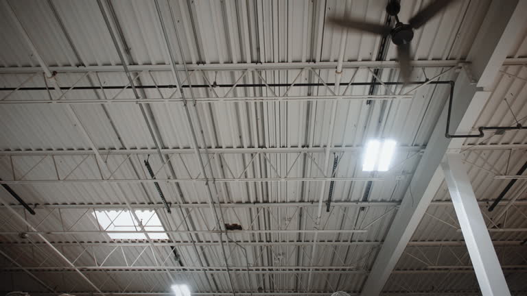 Industrial ceiling fan inside of a large indoor facility warehouse