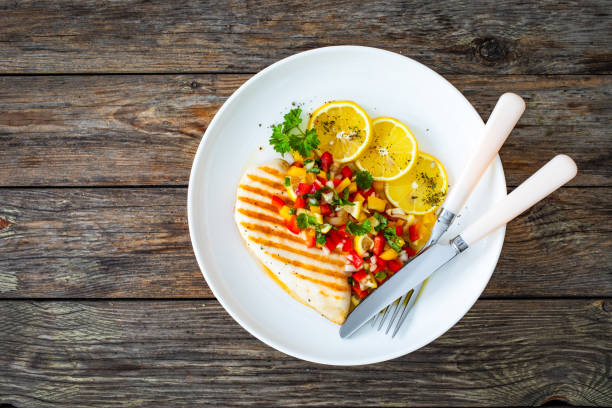 istock Grilled chicken breast and fresh vegetables on wooden table 2150164895