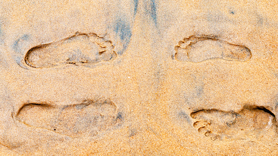 Meeting on the beach, footprints in the sand