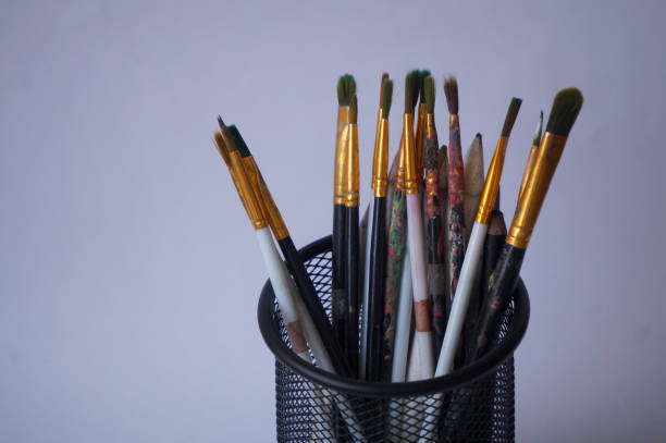 Set of paintbrushes in holder isolated on white background
