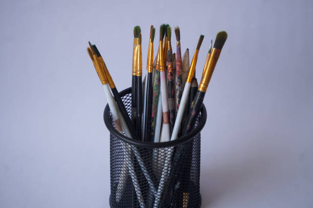Set of paintbrushes in holder isolated on white background