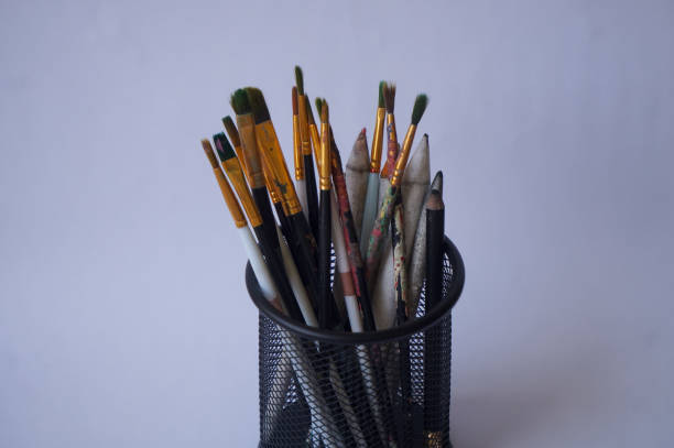 Set of paintbrushes in holder isolated on white background
