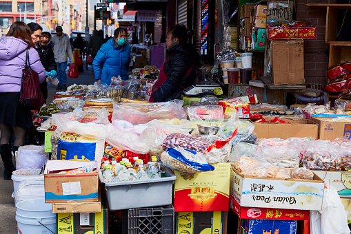 New York (United States), March 3, 2024.  In New York's Chinatown there are many street stalls selling all kinds of products, fish, seafood, legumes, fruits, vegetables, candy, etc.