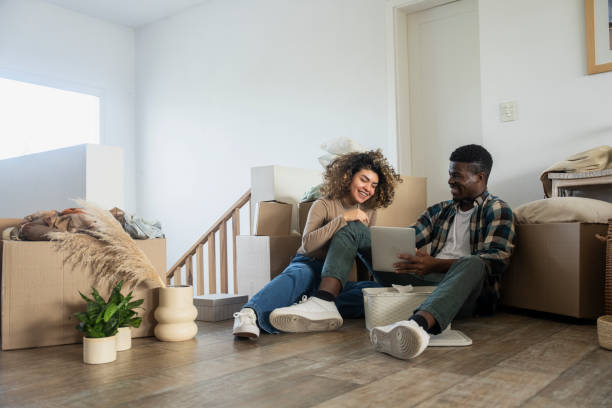 istock Cheerful young couple enjoying a break while moving into new apartment 2150167117