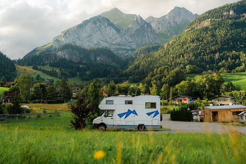 Scenic view of camper van parked on the background of  Swiss Alps in summer