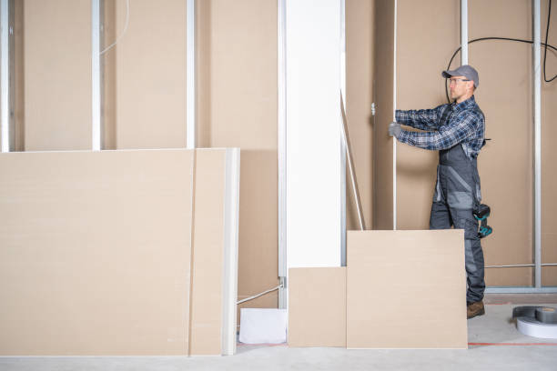 istock Construction Site Contractor Worker Moving Piece of a Drywall 2150167918