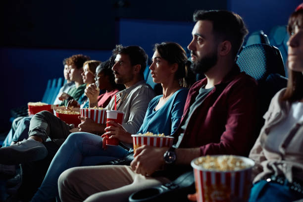 istock Group of people watching suspenseful in cinema. 2150168340