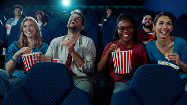istock Happy friends having fun while watching comedy movie cinema. 2150168364