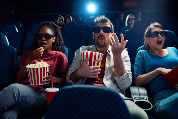 istock Shocked spectators watching 3D movie in cinema. 2150168528