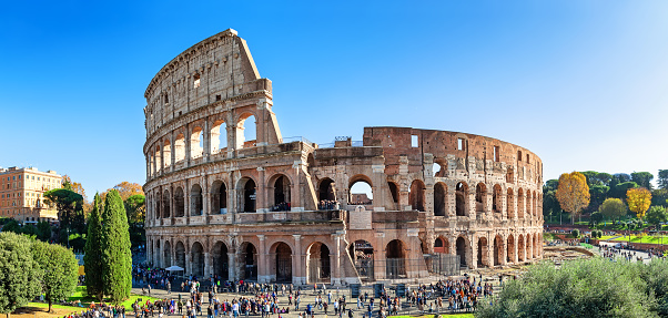 Panoramic view of Colosseum (Coliseum) is one of main travel attraction of Rome, Italy. Panorama of Ancient Roman ruins, landscape of old Rome city.