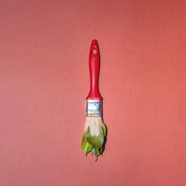 istock Red paintbrush and green leaves 2150169801