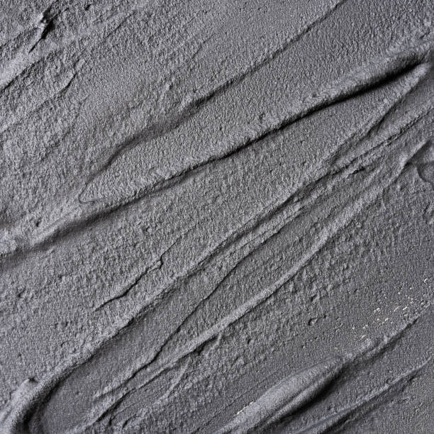 istock Cosmetic black clay close-up textured background 2150170049