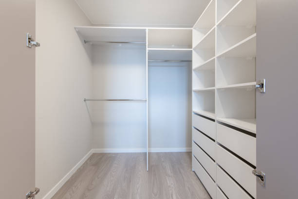 A Small White Walk in Closet With Shelves. Home Interior.