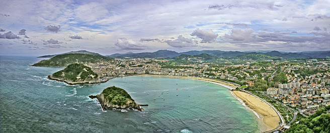 Elevated  panoramic view of San Sebastian, Spain including Santa Clara island, La Concha beach, Mount Urgull and Mount Adarra.
