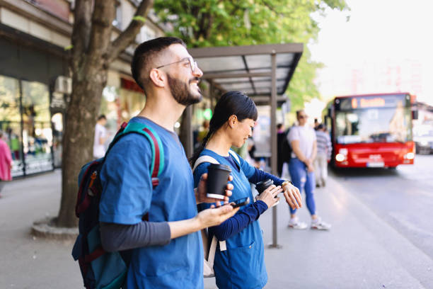 Smiling medical workers waiting for their bus