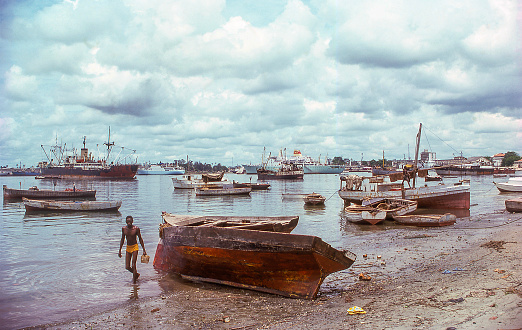 Mombasa, Kenya - May 1975: Old, small oceangoing ships and local boats at Old Port, Mombasa, Kenya.