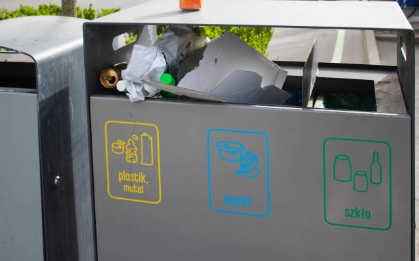 istock Public garbage bin with waste separation on a city street filled with garbage 2150175304