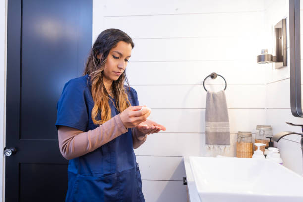 istock Female medical professional gets ready for new workday 2150175998