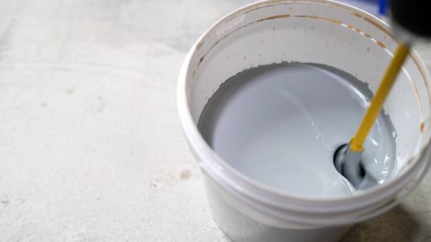 istock The paint is mixed in a bucket. Water based paint. Mixing water-based paint in a bucket using a construction mixer with a whisk. Mixing paint with a drill. 2150177599