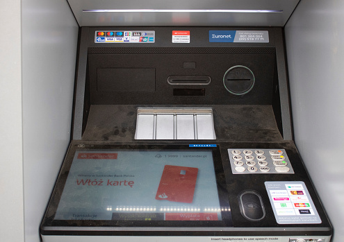 Poznan, Poland - 04.14.2024: Santander ATM installed on the street close-up.
