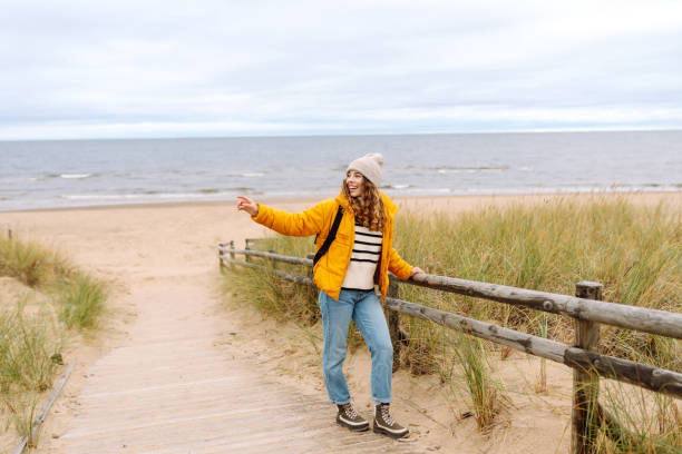istock Happy woman  walks along the seashore. 2150182073