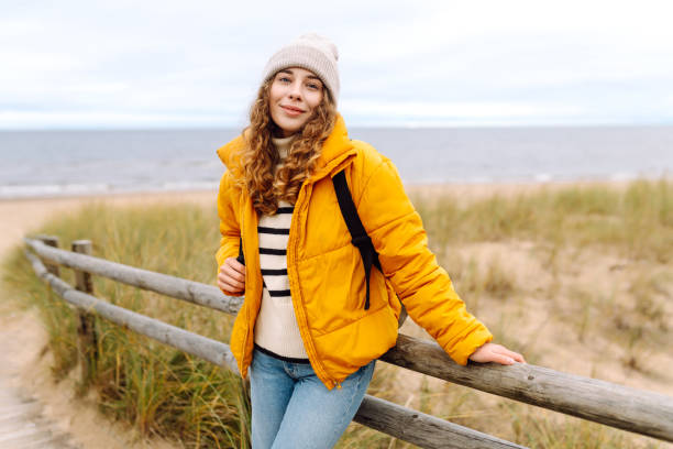 istock Happy woman  walks along the seashore. 2150182074