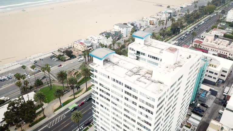 4K Aerial View of Downtown Santa Monica, California with the Santa Monica Pier and the Pacific Ocean in the background with the Beach and Skyscrapers