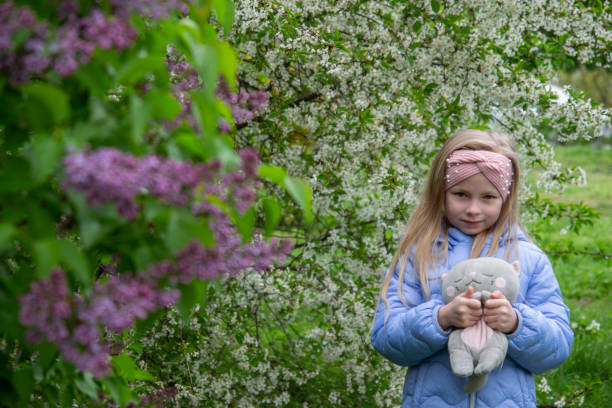 little girl for a walk in a blooming park