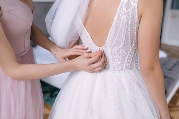 istock bride dressing up in a dress, bridesmaids network, wedding morn 2150187243