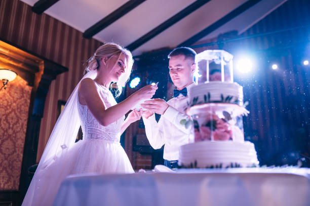 istock Incredible Couple Feeding Each Other A Wedding Cake 2150187921