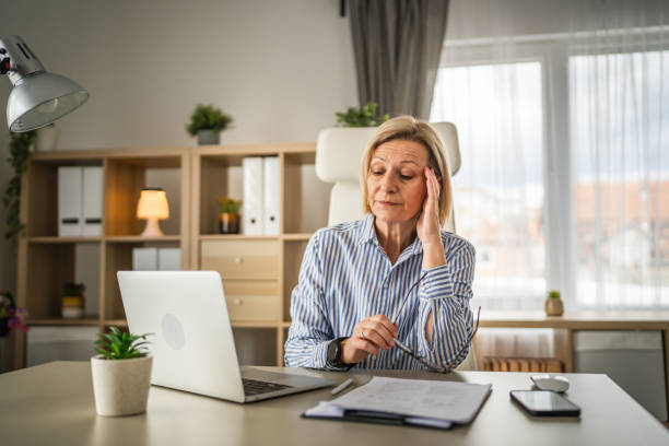 istock Mature woman have headache at office 2150188093