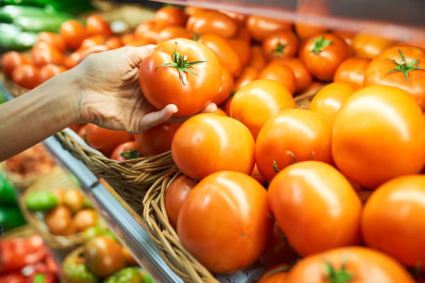 istock Unrecognizable person choosing tomatoes in supermarket 2150188496