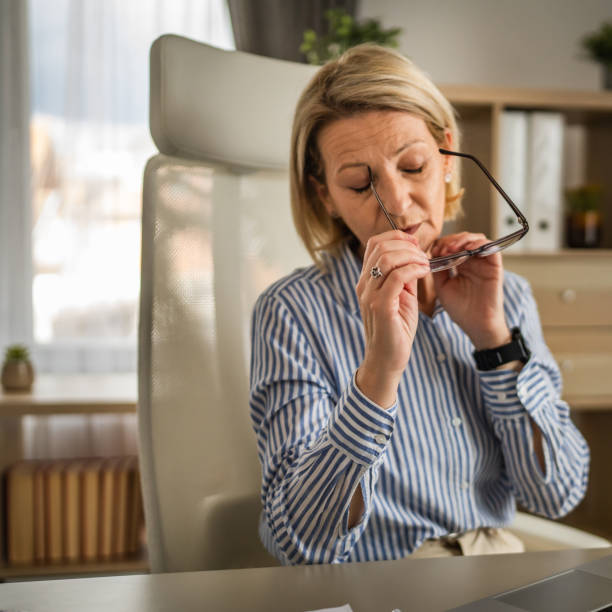 istock Mature woman have headache at office 2150188609