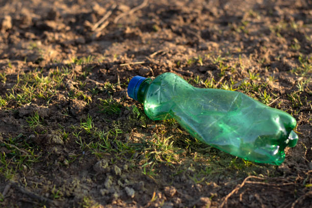 istock Green used plastic bottle thrown on the ground in nature 2150189584
