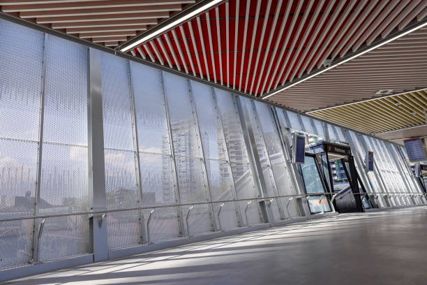 Train station modern pedestrian overpass footbridge with sunlight and shade, Redfern NSW Australia, full frame horizontal composition