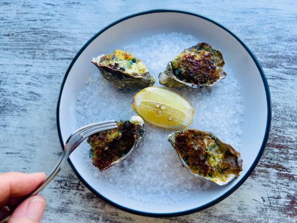 istock Cooked Oysters with Cheese and Spinach Sauce 2150190285