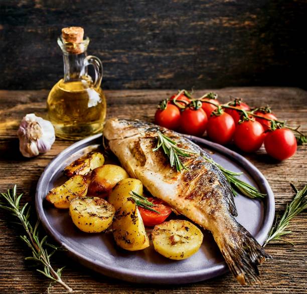 istock Grilled fish with potatoes tomatoes and rosemary 2150192934