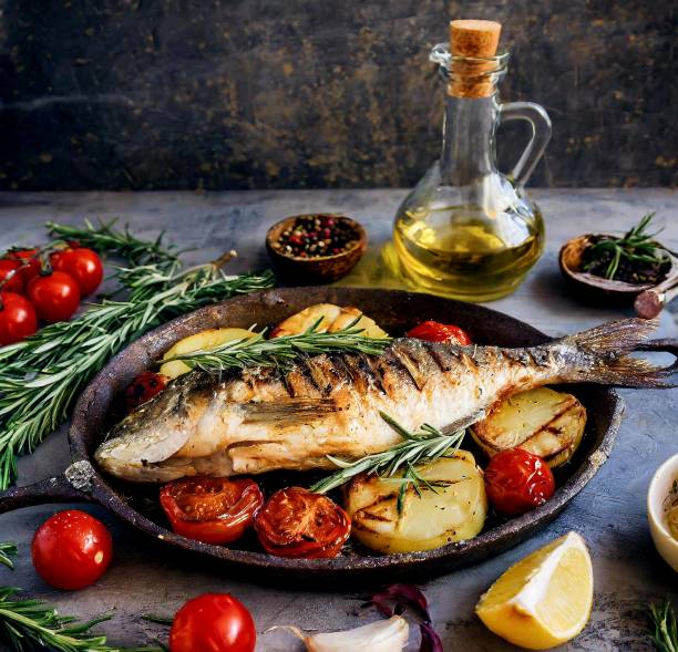 istock Grilled Fish potatoes tomatoes rosemary 2150192957