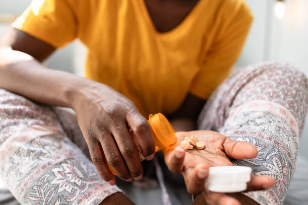 istock Close up on woman's hands taking pills 2150195262