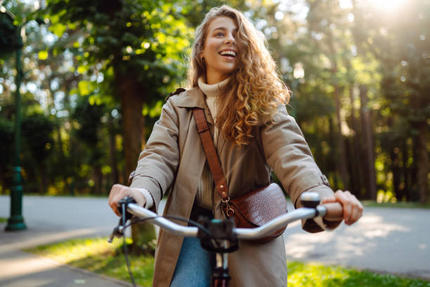 istock Happy woman tourist using bicycle in the park. 2150196568