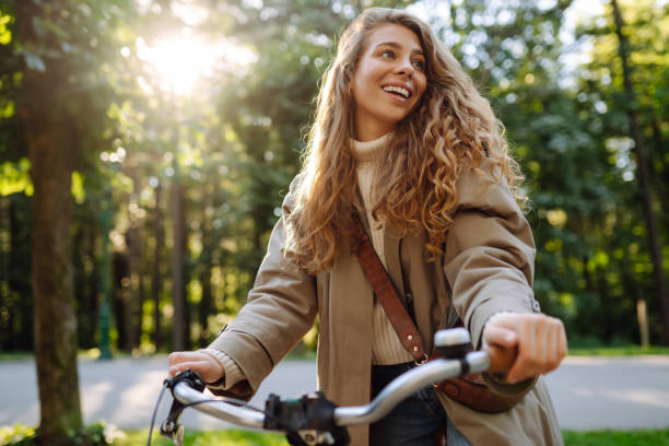 istock Happy woman tourist using bicycle in the park. 2150196572