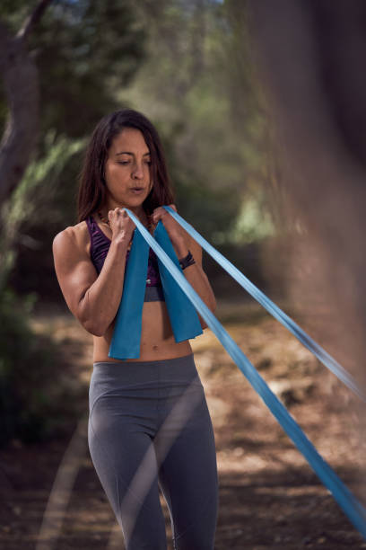 istock Determine female athlete stretching resistance band in countryside 2150196726