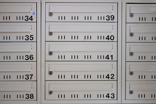 Numbered mailboxes in the entrance of an apartment building.